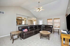 Large living area with comfortable seating and flat screen TV