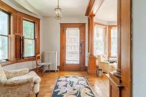 Entrance Hall: Make a grand arrival in this sunlit space with classic wood accents and vibrant decor