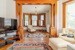 Living Room: Sunlit space with ornate wood accents, plush seating, and cozy vibes for relaxation!