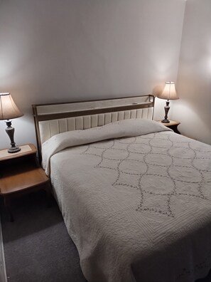 Charming Bedroom: Tranquil retreat with elegant decor and warm lighting for restful nights!