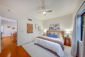 Stylishly-decorated bedroom with king bed and closet