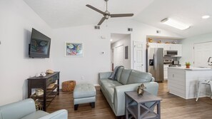 The living space is perfectly comfortable with new, leather furniture.