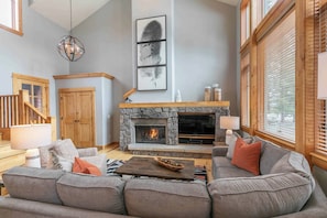 Living room features stone hearth, built-in gas fireplace, and flat screen tv with satellite and streaming options.