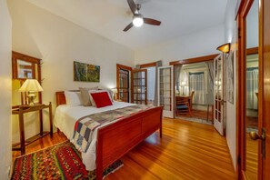 Primary bedroom with queen bed, closet, and private access to side porch
