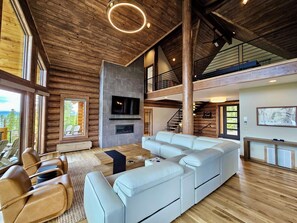 Welcome to our huge living room, complete with a fireplace, 75 inch tv, 