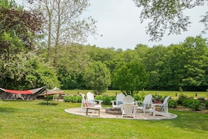 Enjoy sitting outside on the hammocks or by the firepit- behind is the field which is perfect for enjoying a stroll or running with your pup :-)