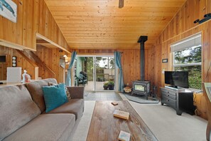 Living room with woodstove, streaming TV, DVD player.