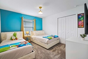 Find solace and tranquility in beautifully crafted bedroom of the townhouse in Davenport Florida - Featuring one double bed and one single bed to relax after the day of adventure - Thoughtfully designed for comfort and style with Super Mario decor