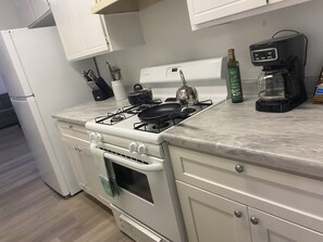 Fully stocked kitchen with all amenities needed to prep a meal .
