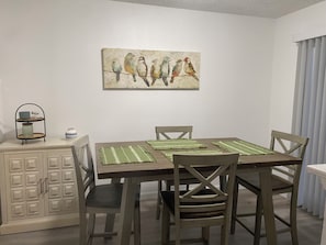 Dining room table adjacent to kitchen& patio.