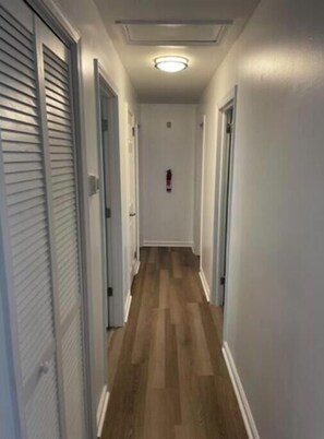 Hallway leading to bedrooms, laundry room and bathroom