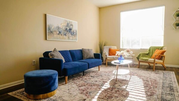 Modern Style Living room with a sofa bed, 2 armchairs, Full-size air mattress, and a 65" Smart TV with (Netflix, Hulu, and Disney+ we logged them virtually) included.