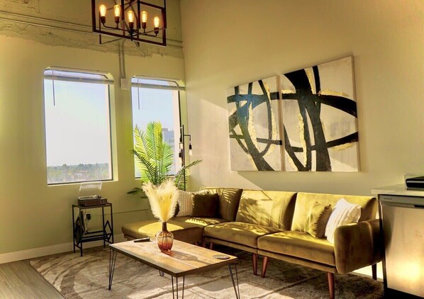 Stylish loft featuring a modern industrial vibe with spacious living, kitchen, dining areas, plus a cozy bedroom and sleek bathroom.