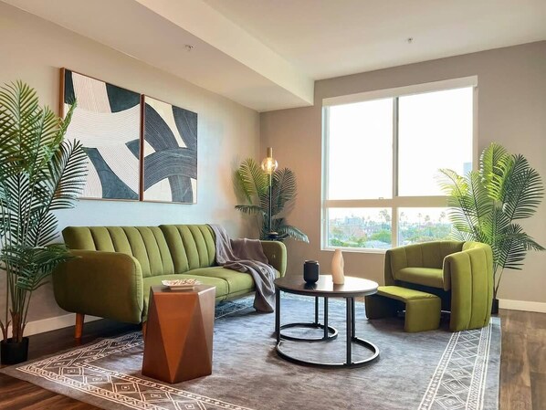 Modern Cosmopolitan Style Apartment with a stunning downtown view  Living room with a sofa bed and a 55" Smart TV (Netflix, Hulu, and Disney+, we logged them remotely) included for free.