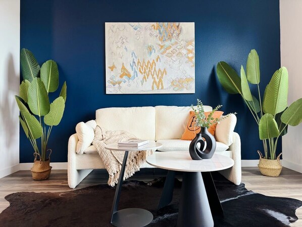 Modern Cosmopolitan Style Apartment  Living room with a sofa, and a 55" Smart TV with (Netflix, Hulu, Disney+ we logged them remotely) included for free.