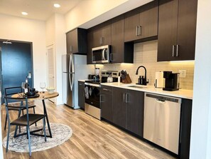 Stay effortlessly at home with our fully equipped kitchen, featuring everything you need for extended comfort: stovetop, refrigerator with freezer, microwave, dishwasher, coffee machine, blender, pots, pans, and kettle.