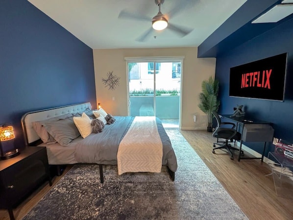 Open Concept Modern 90's Style Apartment  Living room with a sofa bed, velvet accent chair, and a 55" Smart TV (Netflix, Hulu, and Disney+, we logged them remotely) included for free.