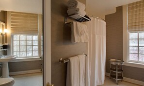 Experience a spacious shower in the well-appointed bathroom, designed with contemporary fixtures and ample lighting.