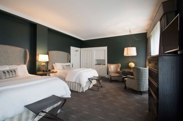 Rest comfortably in this elegant bedroom featuring plush beds, modern decor, and a tranquil ambiance.