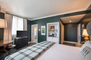 Unwind in the luxurious bedroom featuring a plush king bed, stylish decor, and ample natural light.