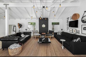 Dramatic gas stone fireplace and flat screen smart TV