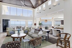 Expansive living area with gorgeous and ornate vaulted ceilings featuring stained mahogany.