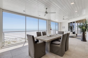 Main level lanai (off living room) with dining area with service for 6 guests, direct beachfront with sliders that can be opened to enjoy your meals a la beach