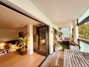 The view from the balcony with doors open, complete with outdoor eating area 
