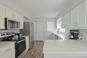 The kitchen of your dreams: marble countertops, all-new stainless appliances, and it's fully outfitted.