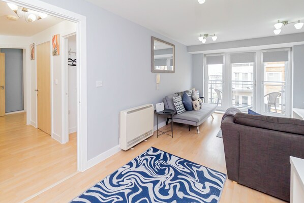 Inviting living room with comfortable seating, perfect for relaxing and unwinding. A cozy space to enjoy your time, whether you're watching TV or simply enjoying a quiet moment.