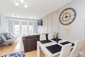 Charming dining area and cozy living room, offering a comfortable space to enjoy meals and relax, perfect for unwinding after a day of exploration.