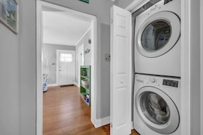 Integrating essential home functions, this setup showcases how a laundry section can seamlessly blend into an inviting and practical entrance.