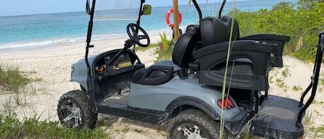 This beautiful new home comes with a golf cart for easy access around the private community of Wykee Estates, including our stunning mile-long beach, pictured here, and our lovely saltwater pool.