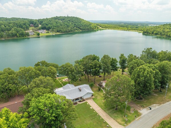 A bird's eye view of the home and lake