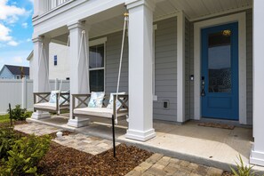 Front porch dual swings and paver landings facing the intercoastal