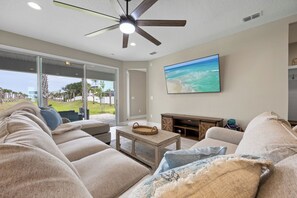 Living room with overstuffed couch and 75" LED TV