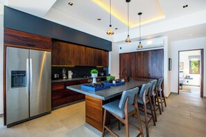 The sleek kitchen is fully-equipped