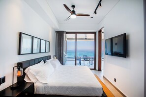 The master bedroom features a comfortable king-size bed, ensuite bathroom, smart TV and a beautiful view
