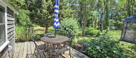Deck has wooded view and is surrounded by mature plantings
