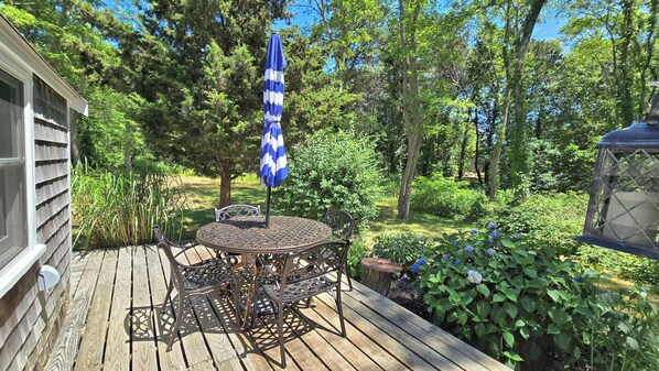 Deck has wooded view and is surrounded by mature plantings