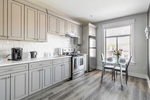 Modern Kitchen With Sleek Cabinetry And A Bright Dining Space
