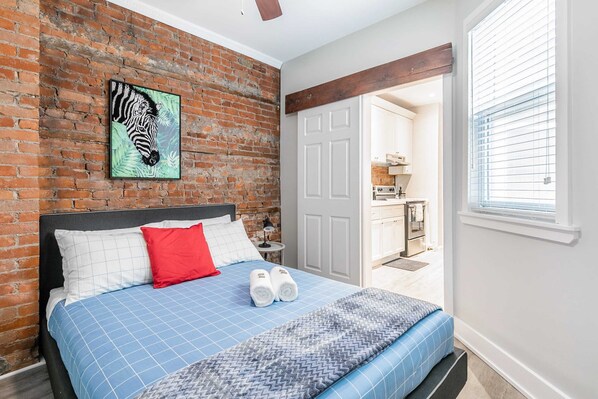Rest In Style With Exposed Brick Charm And Vibrant Accents