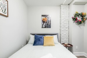 Queen Bed With Soft Pillows And Stylish Decor
