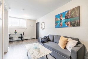 Spacious Living Room With A Comfortable Sofa And Elegant Marble-Style Table