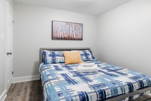 Relax In A Queen Bed With Fresh Linens And Modern Decor