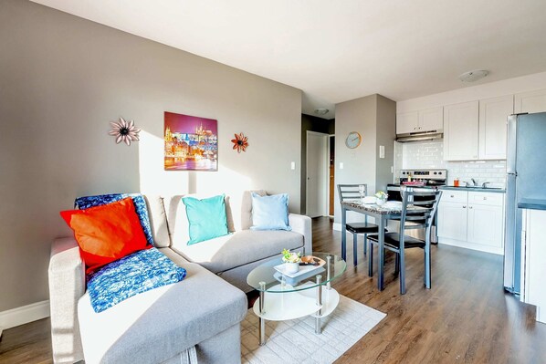 Living Area With Comfortable Sofa Bed And Open Dining Space