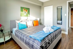 Relax In The Spacious Queen Bed With Vibrant Decor