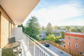 Private Balcony With Comfortable Seating And Scenic Neighborhood Views