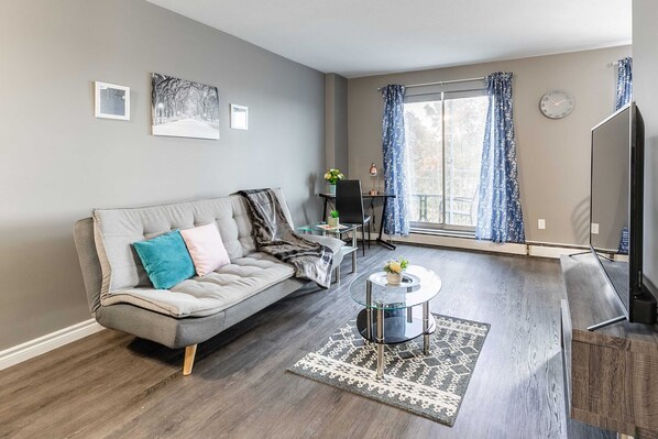 Spacious Living Area Featuring A Sofa Bed And Work Desk