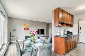 Open Concept Living Area With A Fully Equipped Kitchen And Stylish Dining Table For Four
